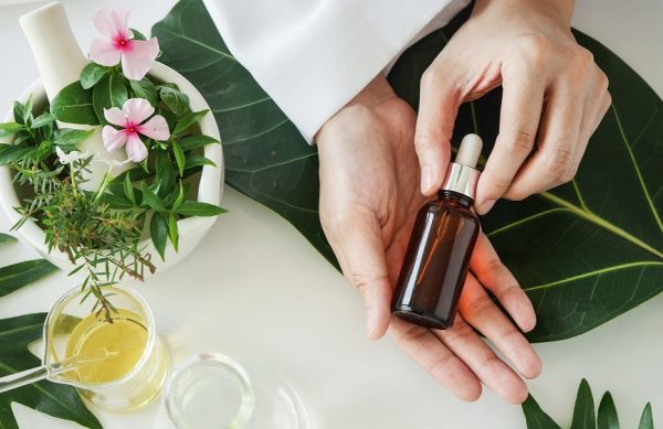 the scientist,dermatologist with the organic natural product in the laboratory.research and development beauty skincare concept.blank package,bottle,container .cream,serum.hand.