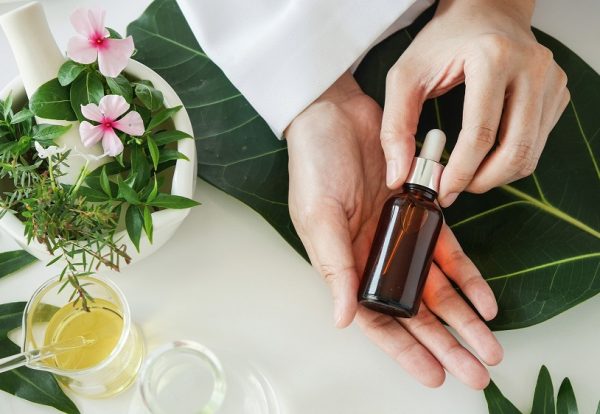 the scientist,dermatologist with the organic natural product in the laboratory.research and development beauty skincare concept.blank package,bottle,container .cream,serum.hand.